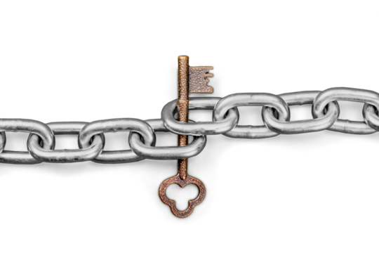 Gold key tangled up in a metal chain