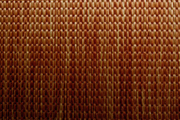 Wicker background made of natural straw. Full frame of densely woven straw pattern. Natural, natural background