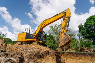 Excavator at earthworks. Construction of a new road.