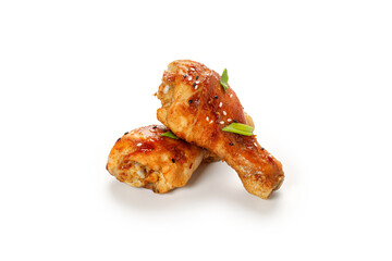 Roasted Baked chicken legs drumsticks, chicken meat with sesame seeds isolated on white background with clipping path, cut out.