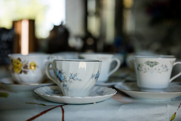Table full of elegant white teacups