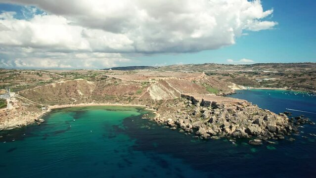 4k aerial drone footage of blue waters and beautiful rocks of Mellieha, Qarraba Bay and Riviera beach near Golden Bay,Malta.Drone moves around beautiful rocks. Beautiful view of Riviera beach and sky.