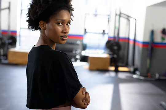 Portrait of african american fit woman with arms crossed at gym