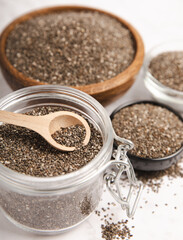 Chia seeds in bowl and spoons on white wood texture. Diet food. Superfood. Healthy food. Space for text, copy space