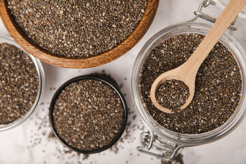 Chia seeds in bowl and spoons on white wood texture. Diet food. Superfood. Healthy food. Space for text, copy space
