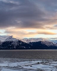 Fototapeta na wymiar Majestic snow-covered mountains in Anchorage, Alaska landscape looking over Chickaloon Bay and Turnagain Arm