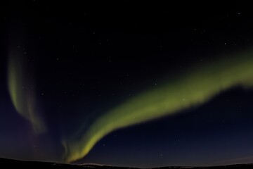 Northern lights, aurora borealis, over winter sky of Alaskan wilderness near Fairbanks, Alaska