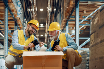 Warehouse workers  scanning barcodes on boxes in warehouse
