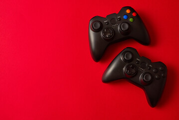 Joystick gamepad, game console on red background. Computer gaming competition videogame control confrontation concept.