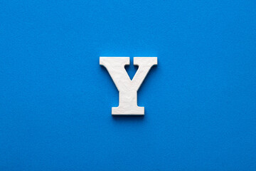 Alphabet letter Y - White wooden letter on blue foamy background