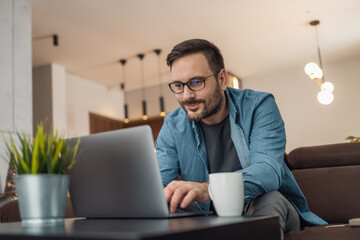 Man using laptop, writing email,online meeting or payment online