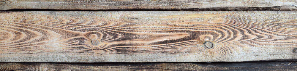 Natural texture from burnt pine boards as a background with copy space.