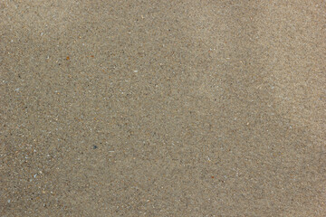 Fototapeta na wymiar Beach wet coarse brown sand Texture for background.