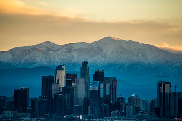 Los Angeles Skyline Contrasts Snow Capped Mountains