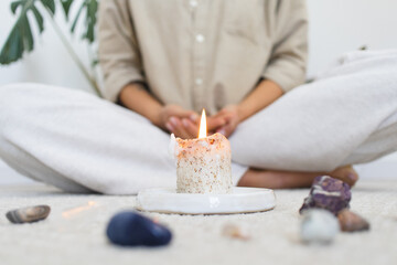 Person Meditating with Candle and Healing Crystals
