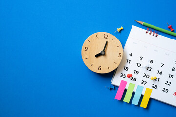 close up of calendar and clock on the blue table background, planning for business meeting or...