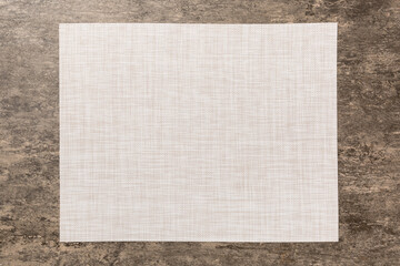 Top view of grey tablecloth for food on cement background. Empty space for your design