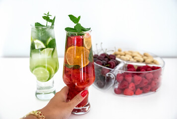 Colorful fruit juices with healthy snacks on the white background