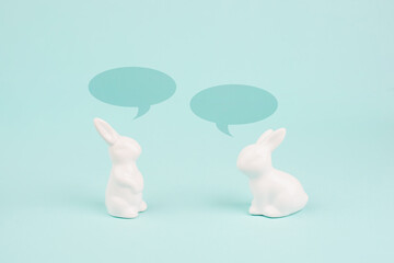 Easter bunny talking together, rabbits have a conversation, spring holiday greeting card with speech bubbles
