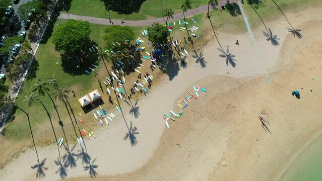 Aerial Panning Shot Of Aloha Formed With Multi Colored Surfboards, Drone Flying Over Beach - Oahu, Hawaii