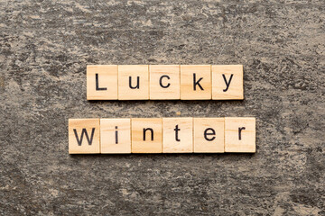 lucky winter word written on wood block. lucky winter text on cement table for your desing, concept