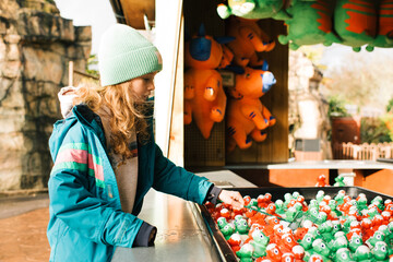 Child playing games at an amusement park trying to win