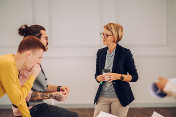 Multiracial team of architects having a meeting while using blueprints