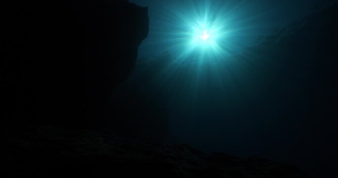 sun rays sun beams and sun shine underwater in cave beautiful light scenery in ocean scuba divers to see