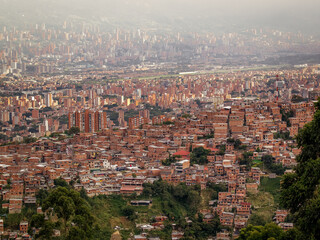 Fototapeta premium The view over Medellín from the station la Aurora of the metro cable in Medellín. The hill village Vallejuelos, Colombia, South America.