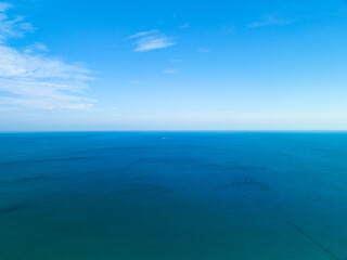 Amazing white clouds with blue sky over calm sea and sunlight reflection, Aerial view open sea...