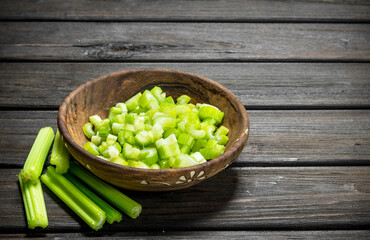 Pieces of celery in a wooden bowl.