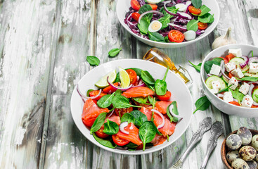 Various salads of organic vegetables, fish and cheese with olive oil and spices .