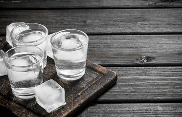 Vodka on the ice on the cutting Board.