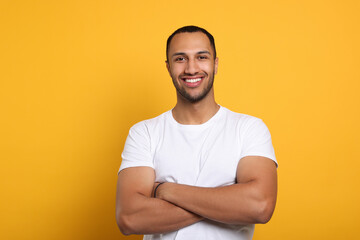 Portrait of happy African American man on orange background