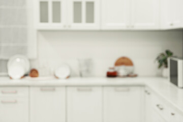 White stylish kitchen with furniture, blurred view. Interior design