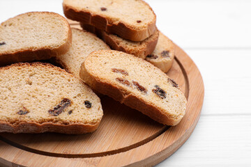 Sweet hard chuck crackers with raisins on white wooden table, closeup