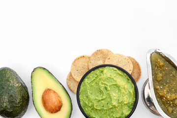 Delicious guacamole made of avocados and nachos on white background, top view