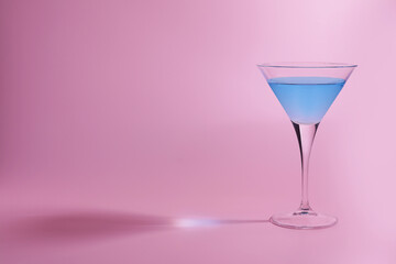 Martini glass with delicious cocktail on pink background, space for text