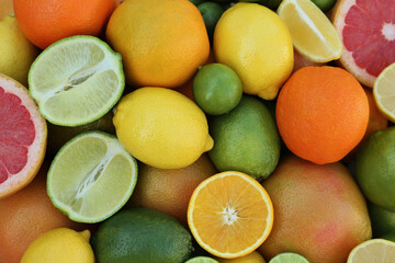 Obraz na płótnie Canvas Different fresh citrus fruits as background, top view