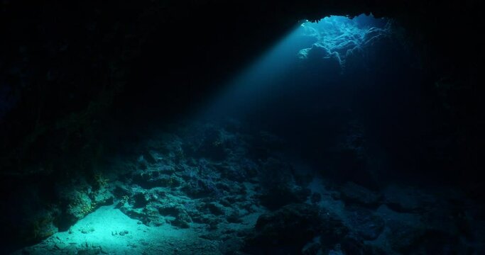 nice light in cave underwater ocean scenery scuba div ers to explore
