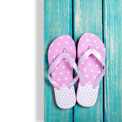 Cute colored flip flops or Pair of sandals on boardwalk.