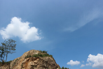 rocky mountain with beautiful blue sky. a rocky mountain that was nearly depleted by mining. environmental issue.
