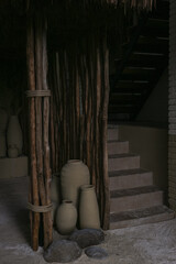 clay pot with bamboo behind it as decoration in a coffee cafe.