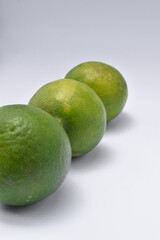 three limes isolated on a white background.