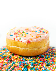 Pink Glazed Donut with Sprinkles on White Background