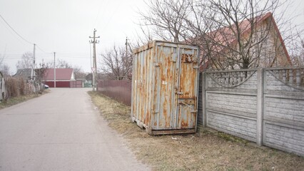 A metal container on the street in the village