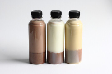 Fresh milk with chocolate pudding on the base, served in plastic bottle, isolated in white background. Fresh and healthy drink idea for small business