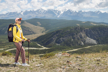 happy woman with backpack  enjoying valley view. Freedom and adventure in nature. Summer vacation in mountains.