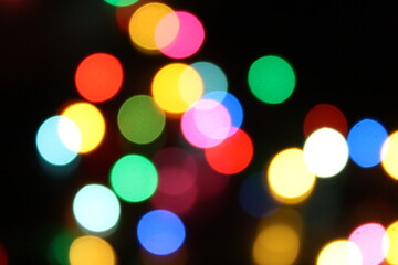 Colorful Bokeh Circle Lights and a few that have cuts in the circles against black background