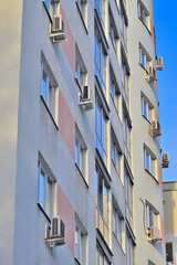 Fragment of the facade of a multi-storey residential building on a winter day